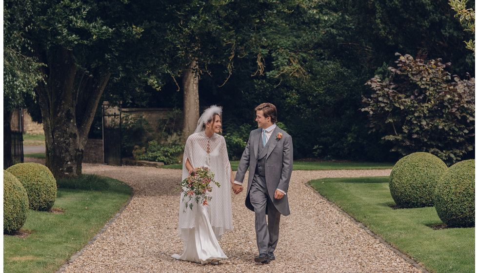 The bride and groom walking down the drive of Jack's parents house where the intimate wedding reception was held.