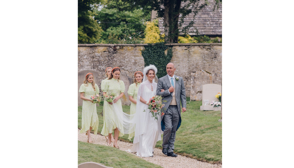 The bride, her father and her bridesmaids on the walk from the house to the Church.