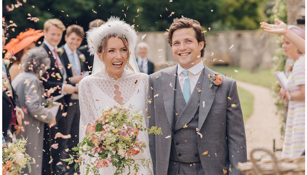 Caz and Jack walking through confetti.