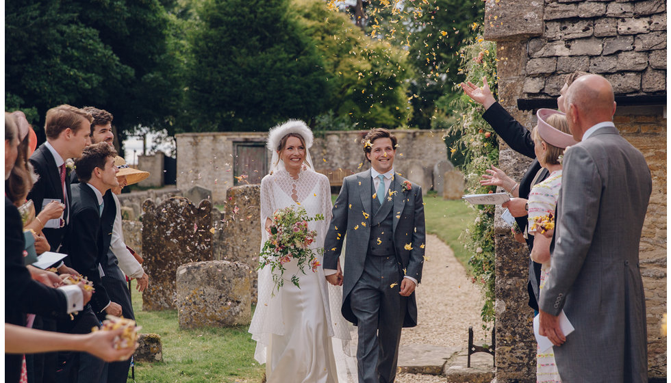 Caz and Jack leaving the Church with their guests throwing confetti.