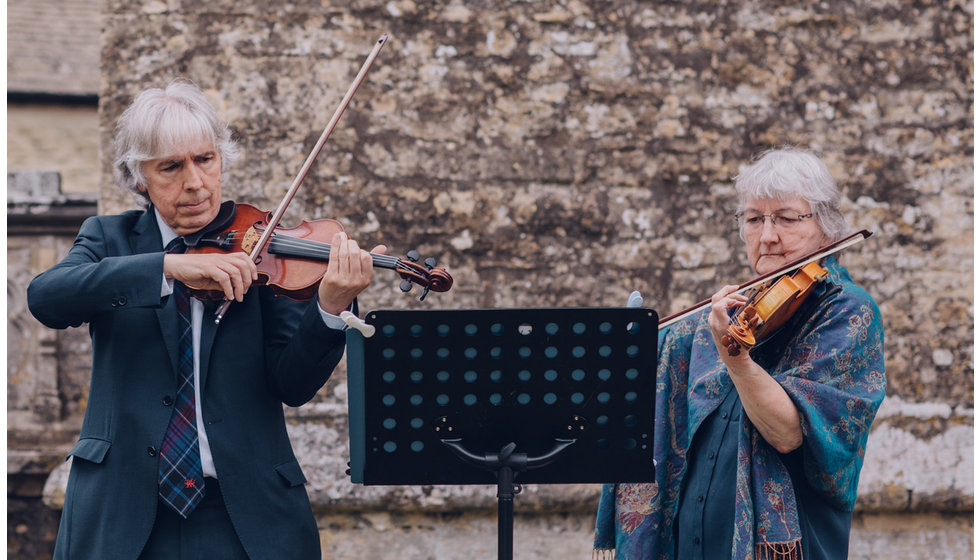 The pair play violin.