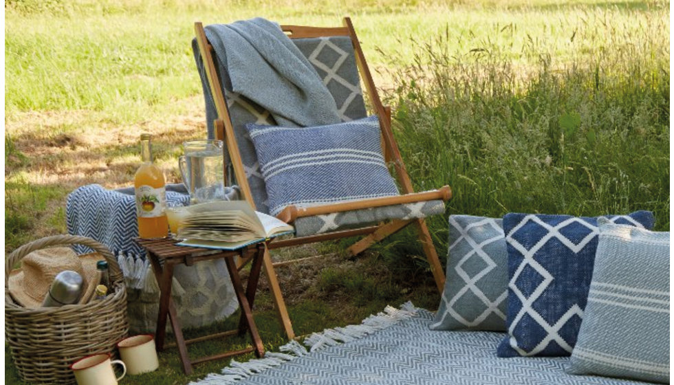 Weaver green set up with a deckchair and cushions.