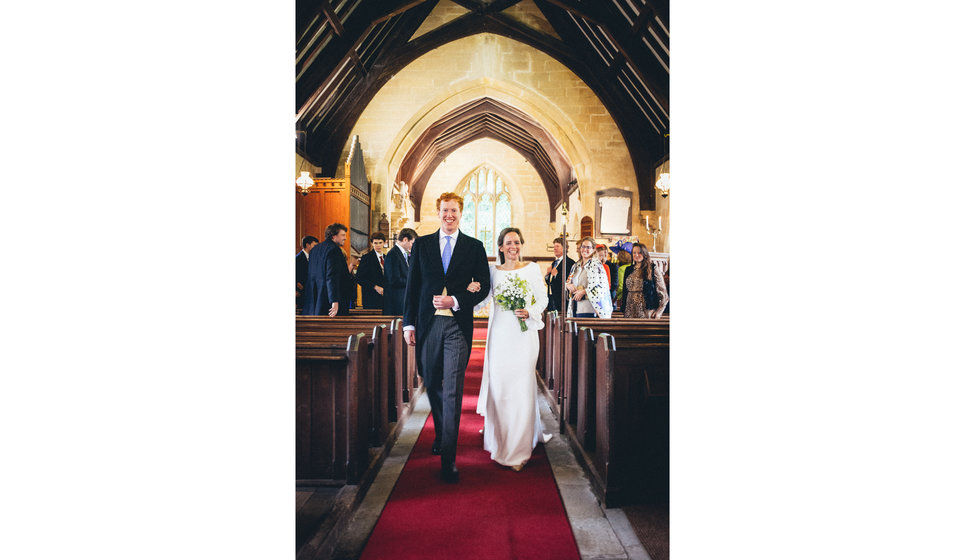 Clare and Henry walk down the aisle.