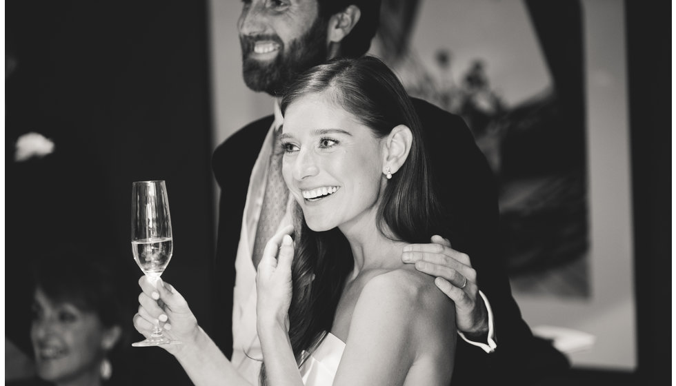 The bride and groom drinking champagne.