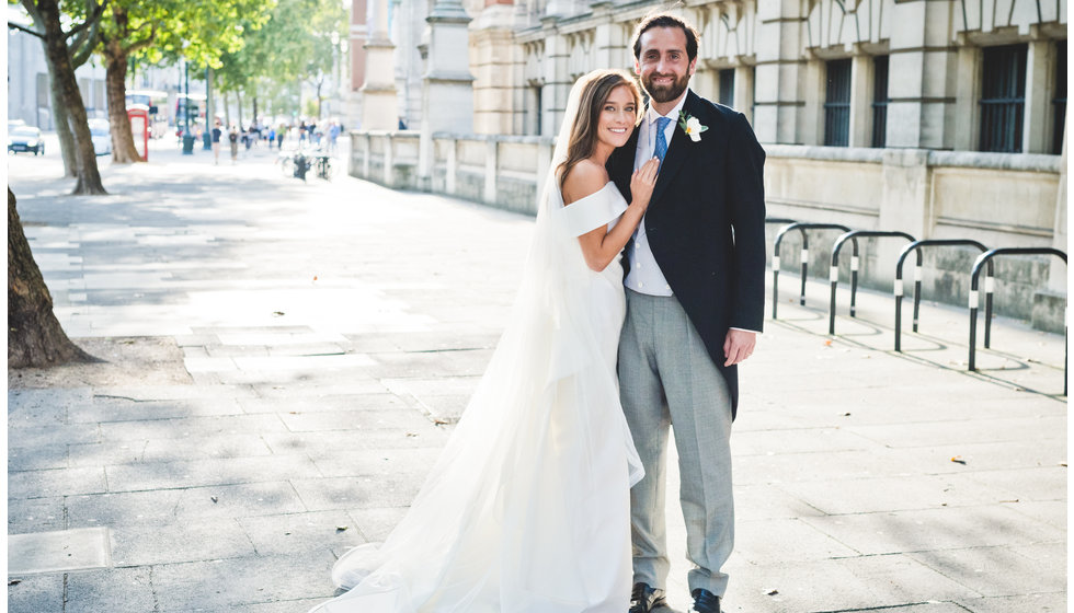 The bride and groom outside in London on a summer's day.