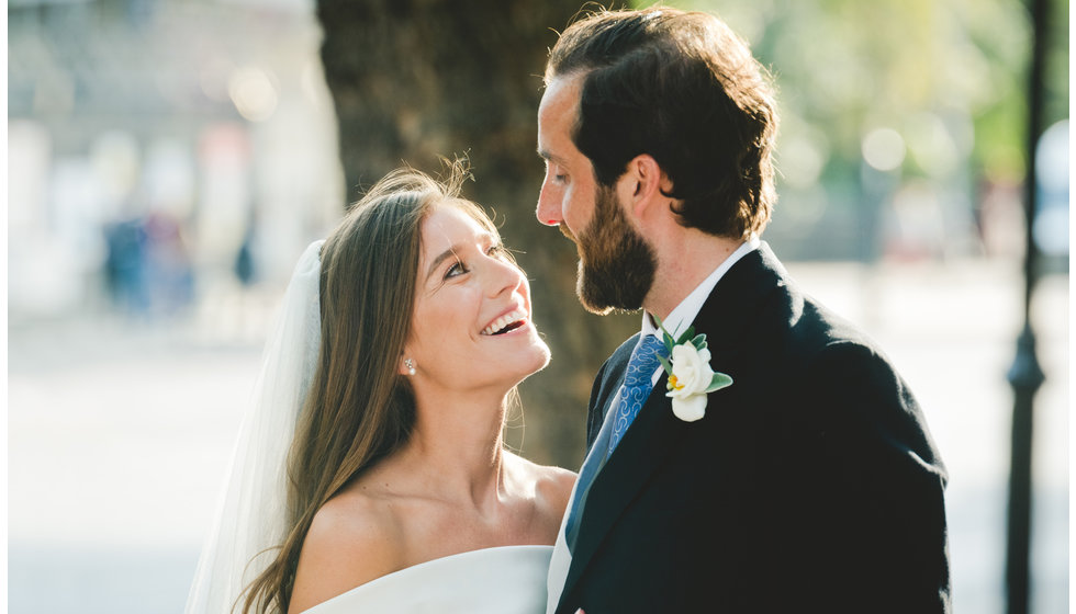 The bride and groom outside in London in the sunshine after their ceremony in the Brompton Oratory.