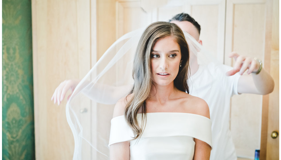 The bride having her veil adjusted.