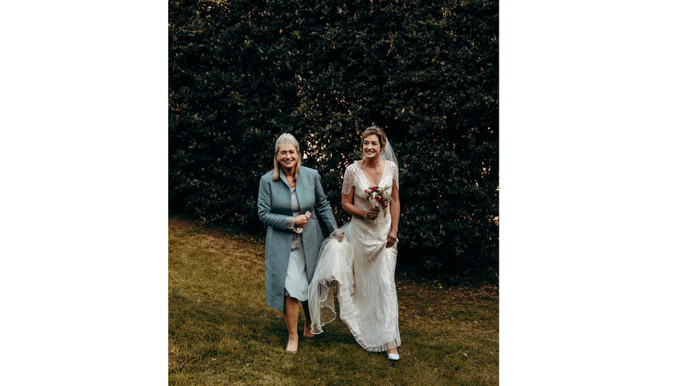 The bride and her mother walking to the Church.