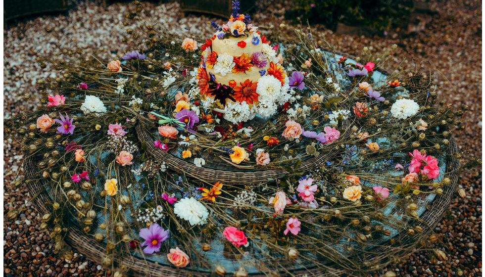 The beautiful wedding cake made by the brides friends and family.