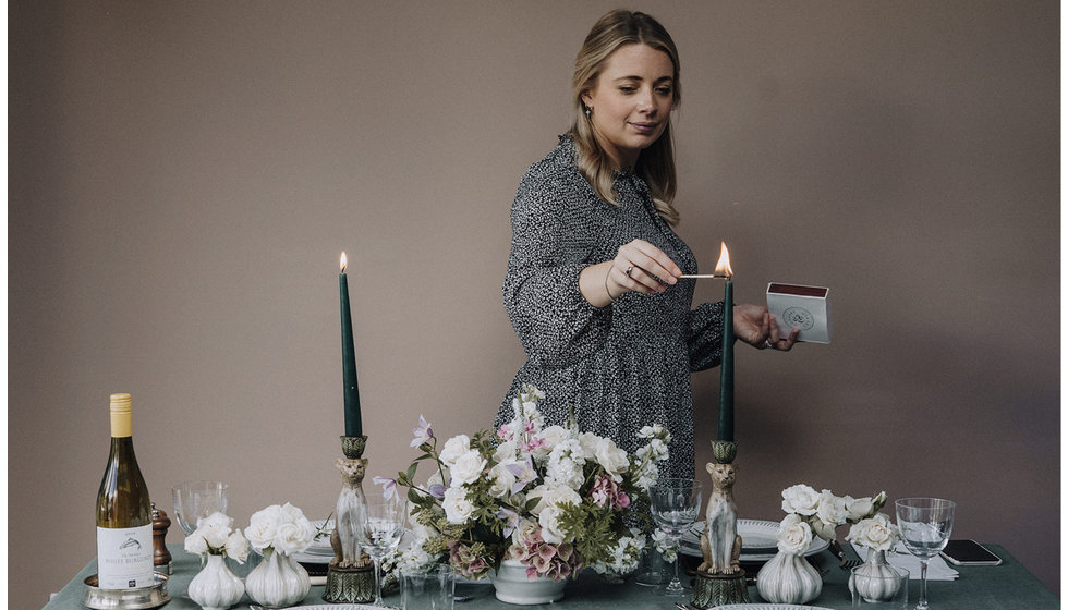 Our MD lighting a candle on a formal table.