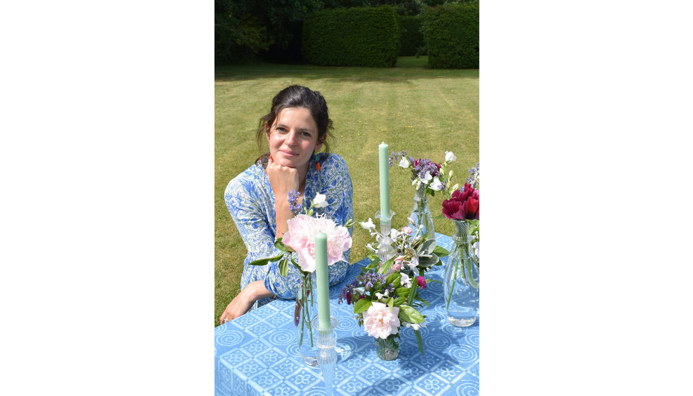 A portrait of Issy Granger with a selection of her glassware.