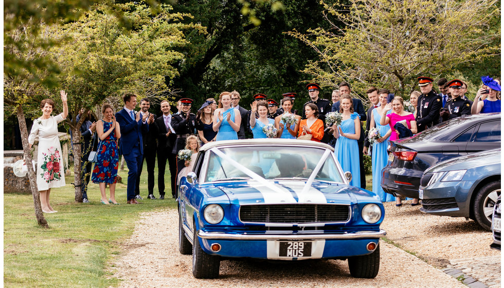 The bride and groom leaving in their vintage ford focus. 