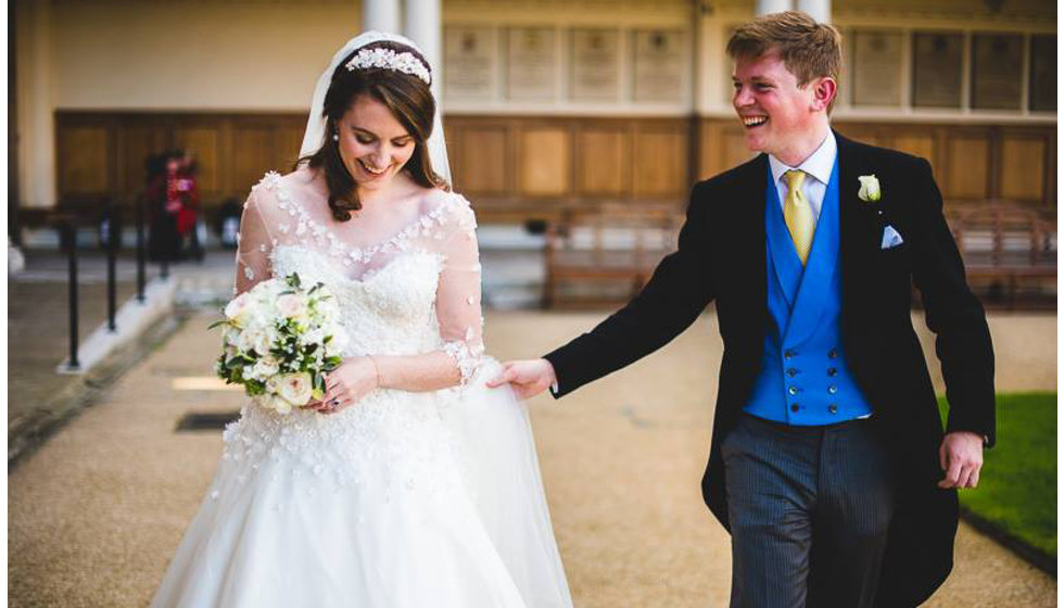 The bride and groom outside The Royal Hospital Chelsea on a sunny September day.