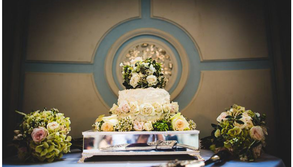 The bride and grooms simple yet elegant wedding cake - decorated in real flowers. 