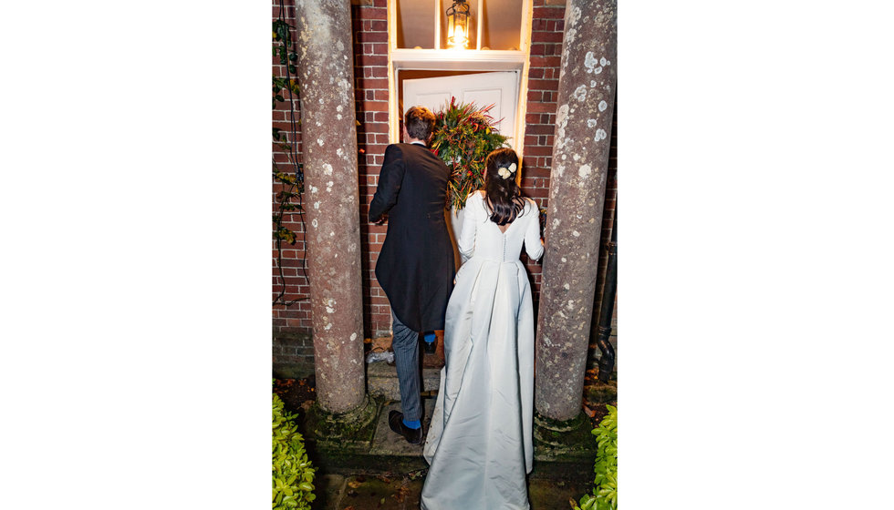 Edwina and Edward walking into their house. 