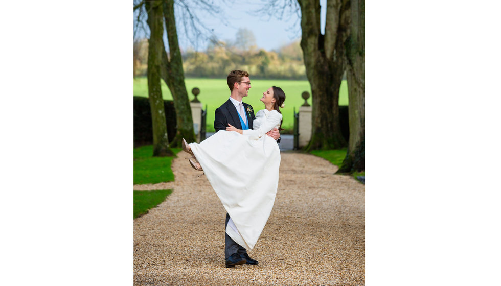 Edward carrying Edwina for a photograph outside. 