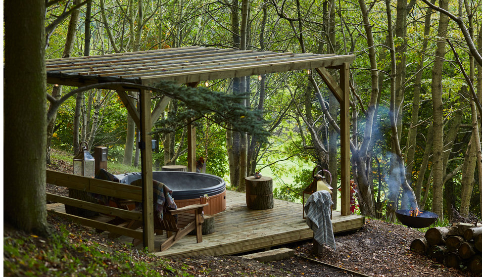 An outdoor set up with a fire pit in the grounds of boutique hotel - The Foxhill Manor. 