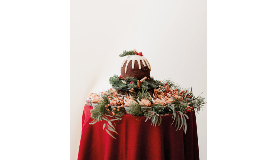 Sarah and Fergus' Christmas Pudding Cake surrounded by individual cupcakes.