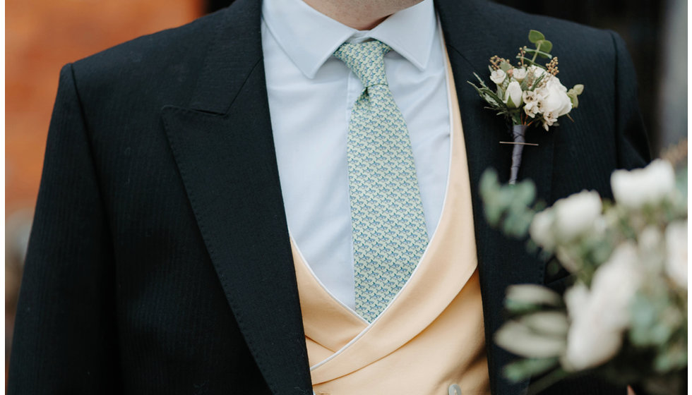 Furgus wore a blue shirt and tie, a yellow waistcoat and a morning suit.