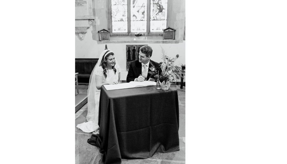 Sarah and Fergus signing the register.