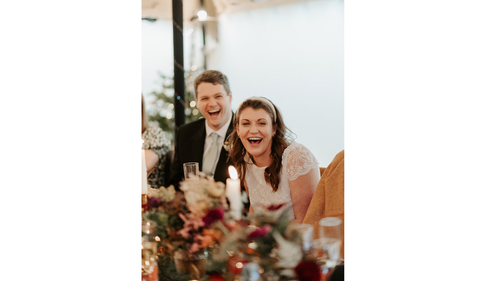 Sarah and Fergus laughing during the speeches.