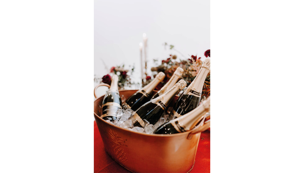 A champagne bucket filled with Champagne at a wedding reception.