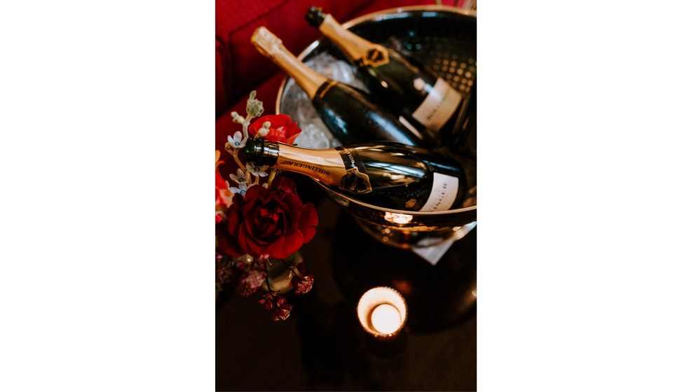 Champagne bottles chilling in an ice bucket.