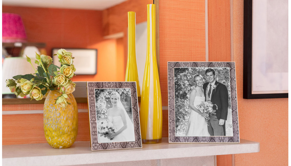 An mantlepiece with two frames.