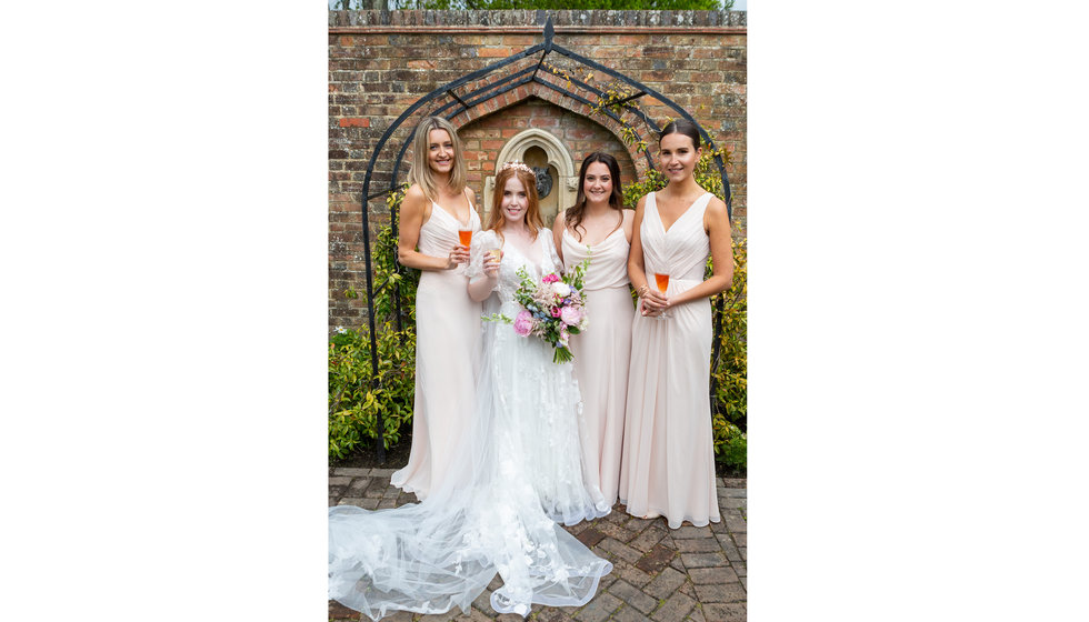 Sarah and her 3 bridesmaids who wore sleeveless pink dresses.