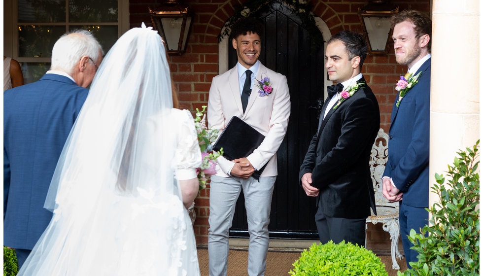 Sarah being walked down the aisle by her father, with Nico his best man and the celebrant.