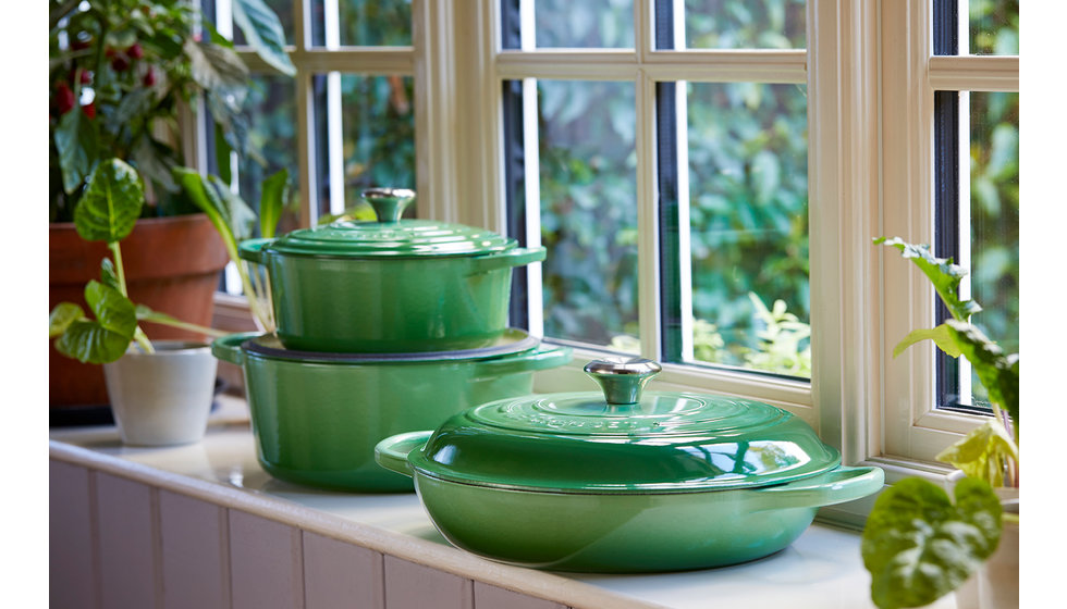 Le Creuset Rosemary cast iron pots on a windowsill. 