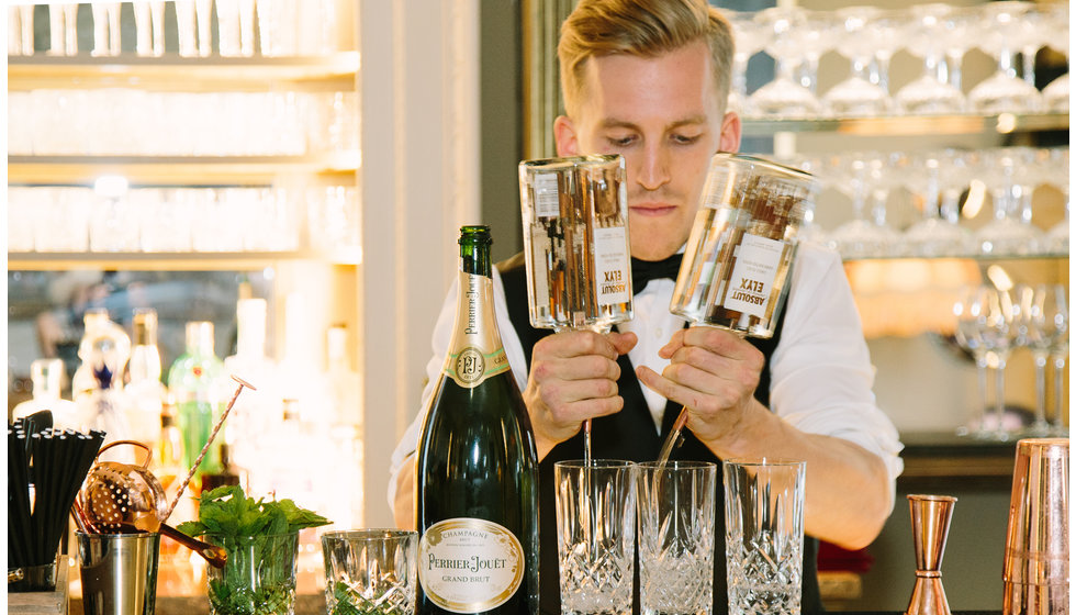 A mixologist from The Cocktail service in action making a cocktail.