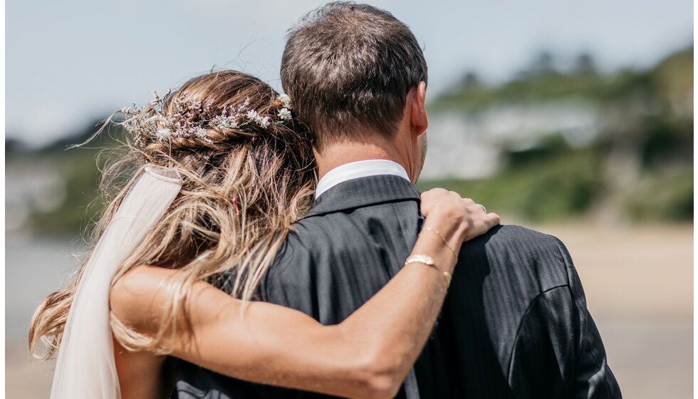 Newlyweds Chloe & Ed enjoy a moment on the beach in Rock, Cornwall