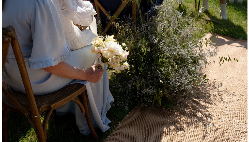 Charlotte & Harry's Magical Meadow Marquee Wedding in Oxfordshire: A detail on soft golden-coloured walkway with Long grassy ‘dune like’ foliage lining the  wedding aisle isle