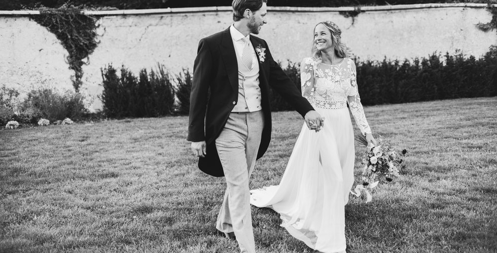 Newlyweds Poppy and Jamie in the grounds of their wedding venue.