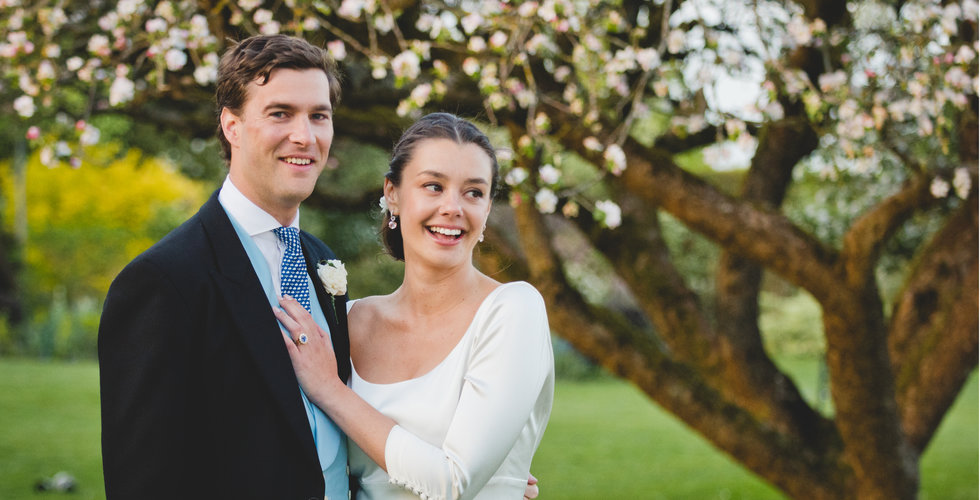 Charlotte and Will outside by some blossom.