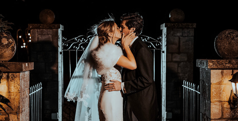 Sam and Rebecca kiss outside the gates of their venue.