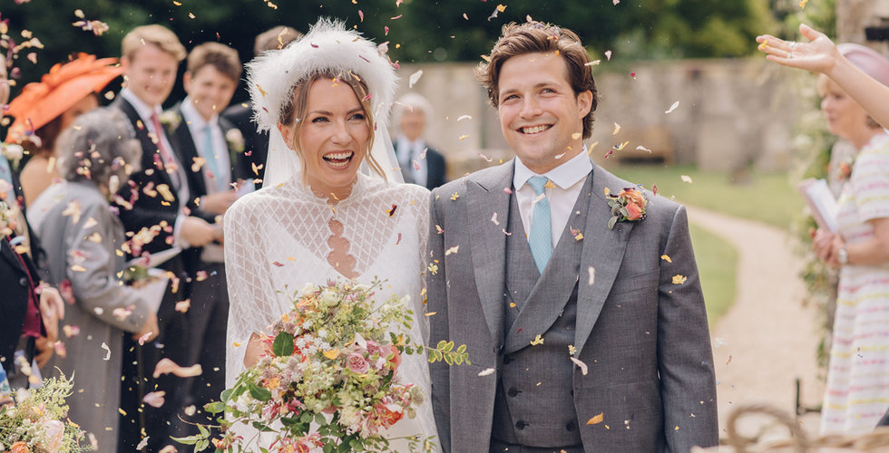 Caz and Jack walking through confetti.