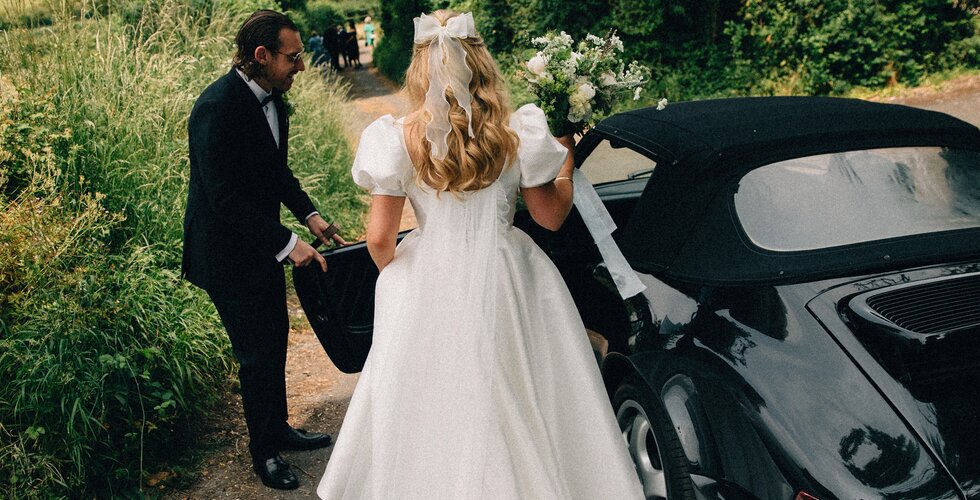 The Wedding Present Company | Bride and groom getting into a vintage car for their whimsical Tuscan-inspired wedding in Hampshire